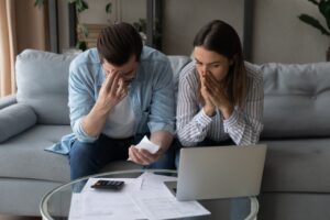 Young couple stressing over finances